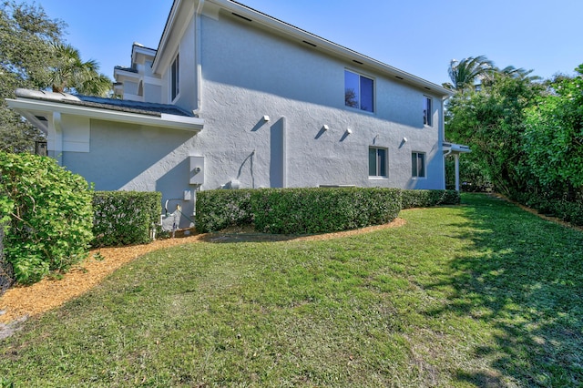 rear view of house featuring a lawn