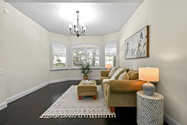 sitting room featuring dark hardwood / wood-style floors and a notable chandelier