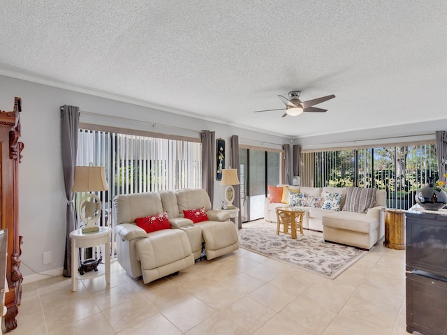 living room featuring ceiling fan, light tile patterned flooring, and a textured ceiling