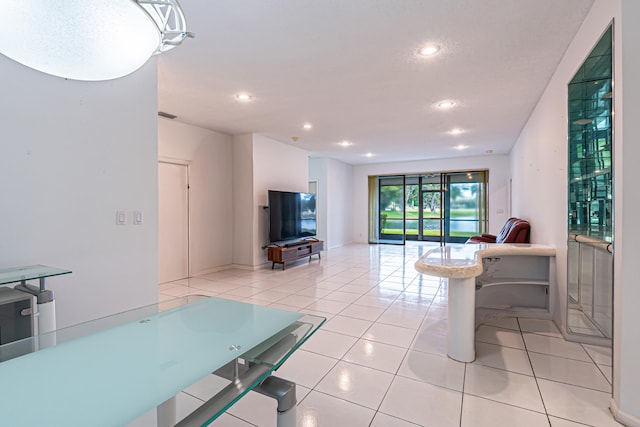 game room featuring wine cooler, a textured ceiling, and tile patterned floors