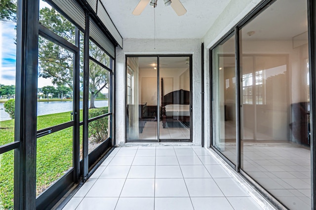 unfurnished sunroom featuring ceiling fan