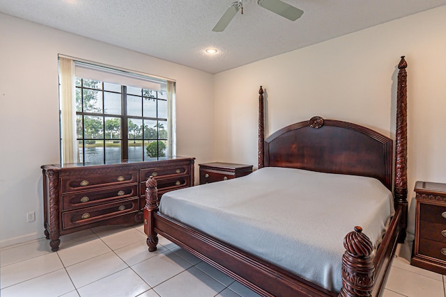 bedroom with ceiling fan and light tile patterned floors