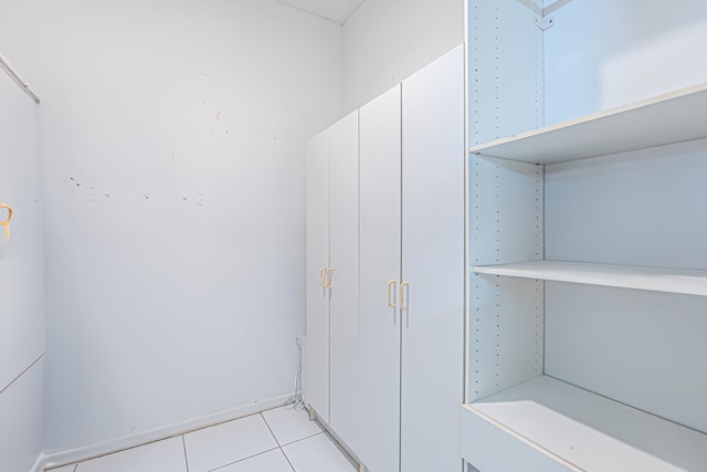 bathroom with vanity, tile patterned flooring, and plus walk in shower