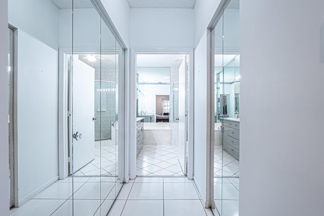 bathroom with tile patterned flooring, vanity, and shower with separate bathtub