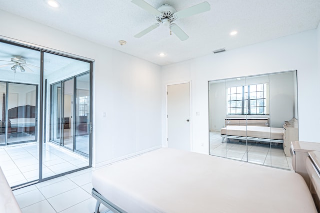 bedroom featuring ceiling fan, a closet, and light tile patterned flooring