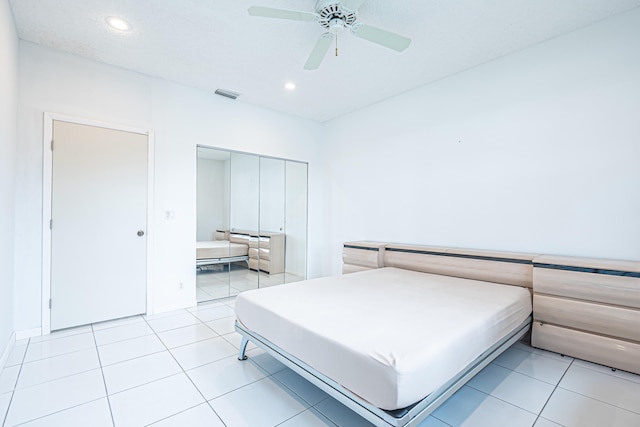 bathroom with tile patterned flooring, a healthy amount of sunlight, and a textured ceiling