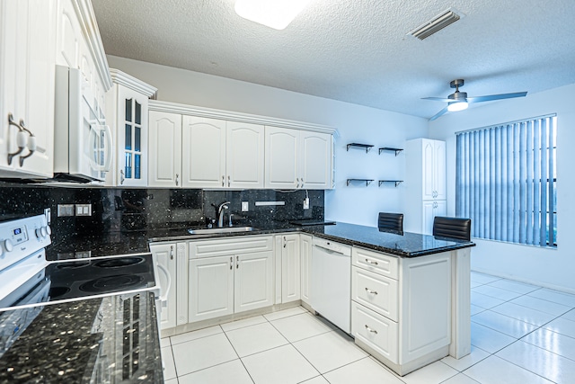 kitchen featuring white cabinets, decorative backsplash, white appliances, and separate washer and dryer