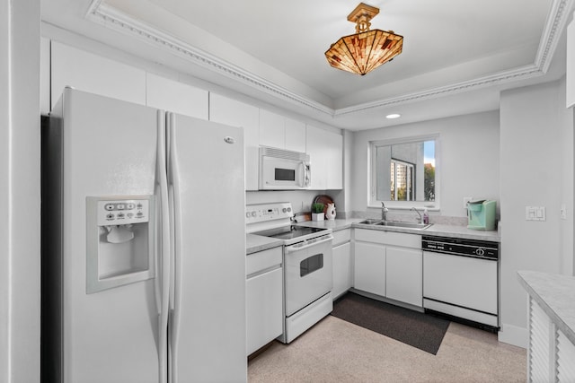 kitchen featuring sink, white cabinets, decorative light fixtures, and white appliances