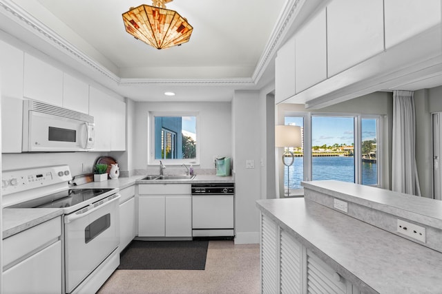 kitchen featuring ornamental molding, white appliances, sink, a water view, and white cabinets