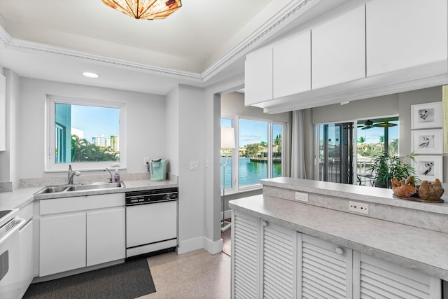 kitchen with white appliances, sink, a water view, white cabinets, and plenty of natural light