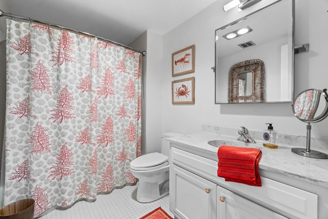 bathroom with tile patterned flooring, vanity, and toilet