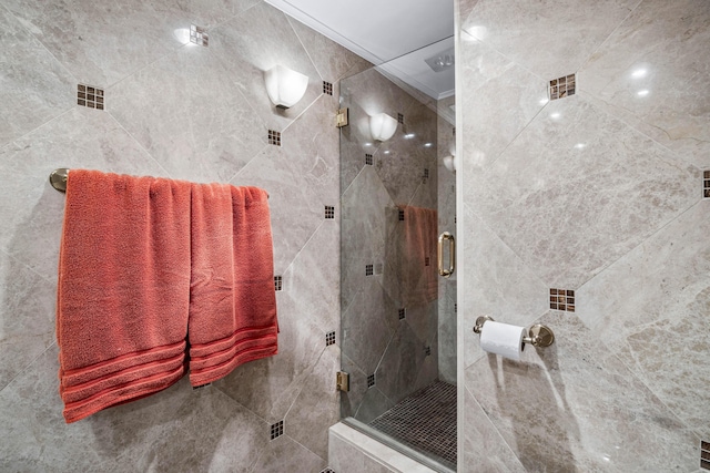 bathroom featuring a shower with shower door