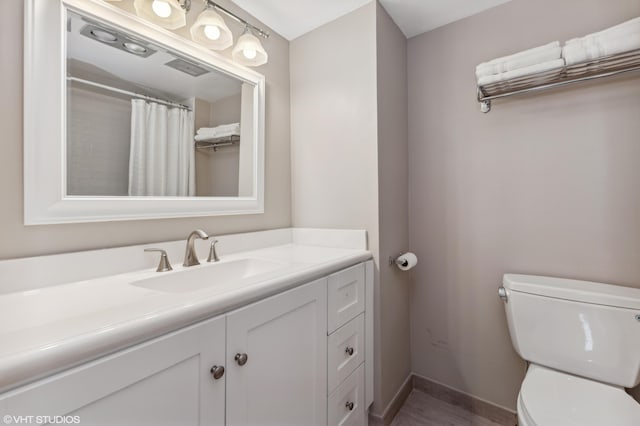 bathroom featuring vanity and toilet