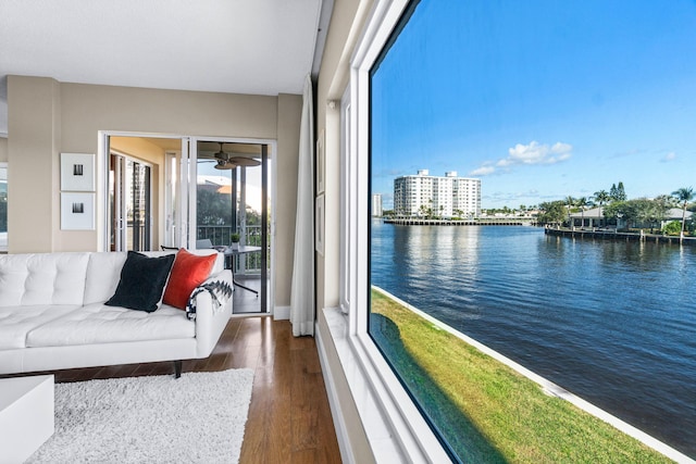 interior space with a water view and ceiling fan