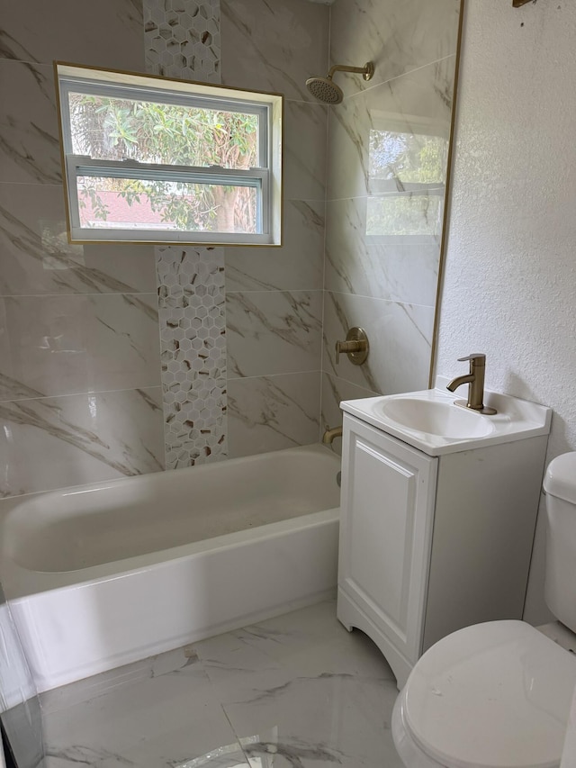 full bathroom featuring toilet, marble finish floor, vanity, and shower / bathtub combination