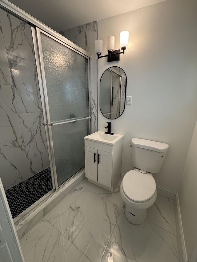 full bath featuring a marble finish shower, baseboards, toilet, marble finish floor, and vanity