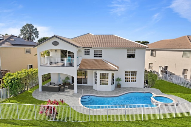 back of house with a patio, a balcony, a lawn, an outdoor hangout area, and a pool with hot tub