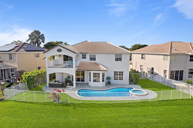 rear view of house with an outdoor living space, a balcony, a yard, and a patio area