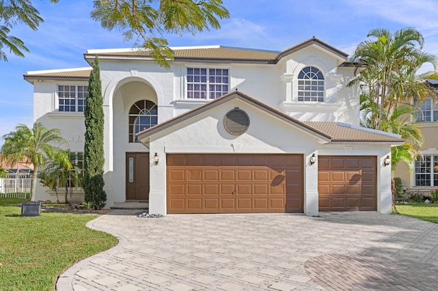 mediterranean / spanish house featuring a garage