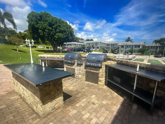 view of patio with area for grilling and exterior kitchen