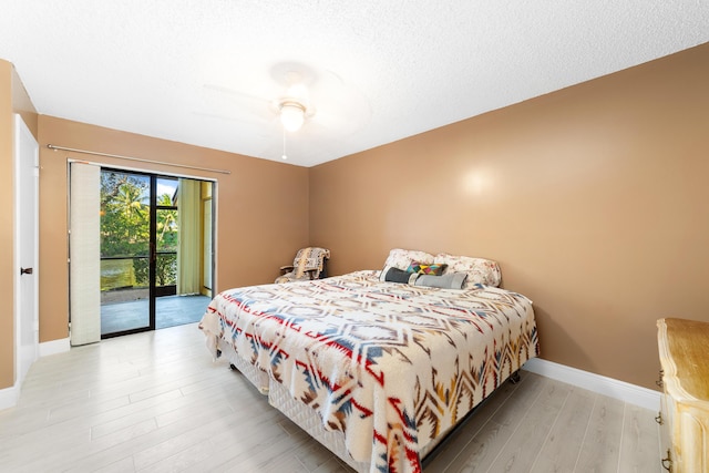 bedroom with access to exterior, ceiling fan, a textured ceiling, and light wood-type flooring