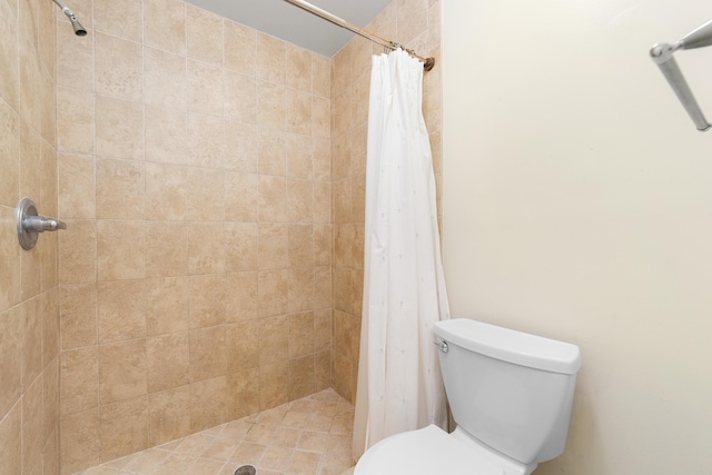 bathroom featuring walk in shower and toilet