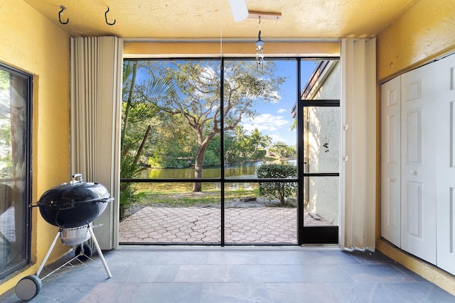 doorway to outside with french doors and a textured ceiling