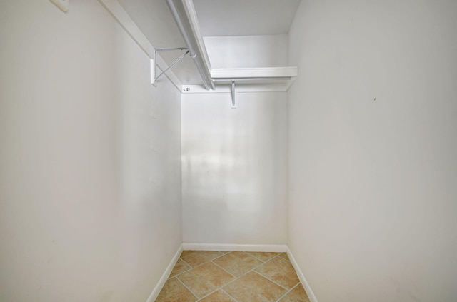 spacious closet with tile patterned floors