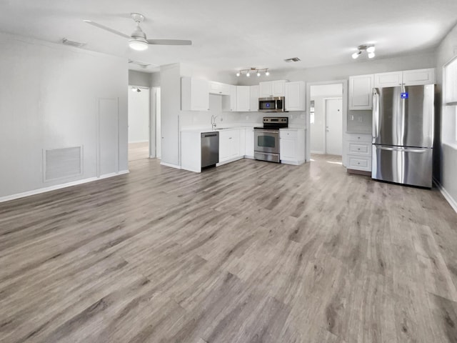 kitchen with ceiling fan, sink, stainless steel appliances, light hardwood / wood-style flooring, and white cabinets