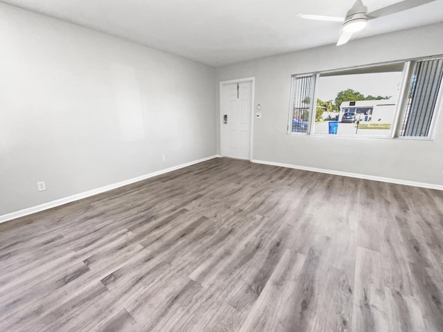 empty room featuring ceiling fan and hardwood / wood-style flooring