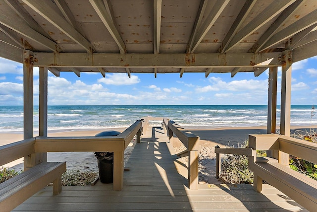 deck with a beach view and a water view