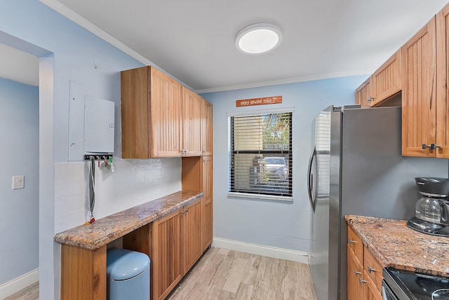 kitchen featuring decorative backsplash, stove, ornamental molding, stone countertops, and light hardwood / wood-style flooring