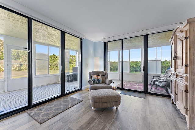 interior space with ornamental molding and light wood-type flooring