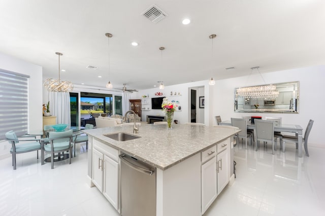kitchen with white cabinetry, decorative light fixtures, dishwasher, and sink