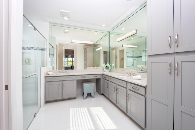 bathroom with vanity, tile patterned flooring, and a shower with door