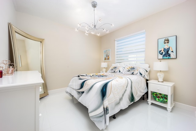 bedroom with a notable chandelier and light tile patterned floors