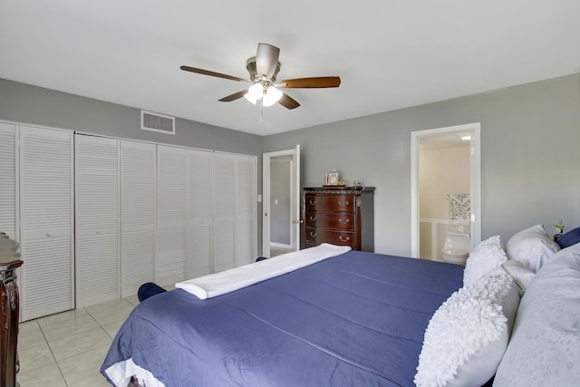 bedroom featuring ceiling fan, light tile patterned floors, and ensuite bathroom