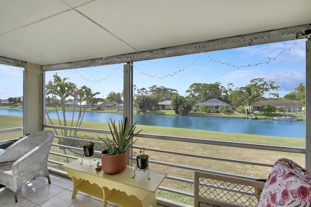 sunroom / solarium featuring a water view