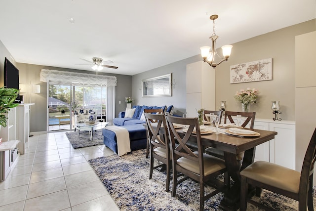 dining area with ceiling fan with notable chandelier and light tile patterned flooring