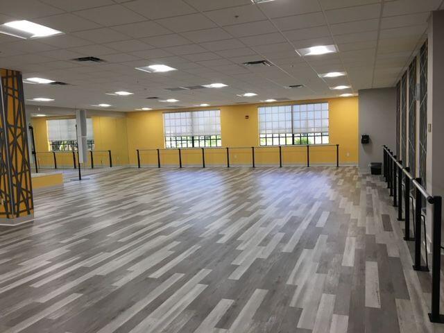 exercise room featuring a paneled ceiling and wood-type flooring