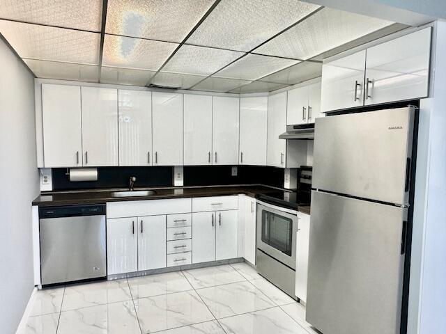 kitchen with white cabinets, sink, and appliances with stainless steel finishes