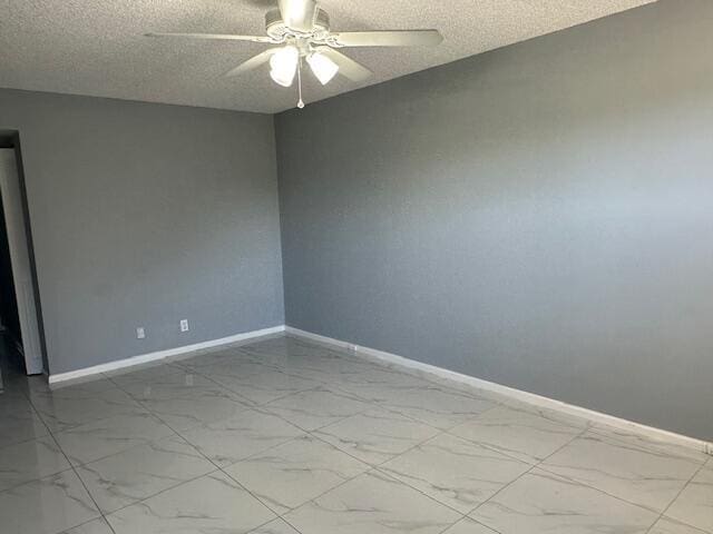 empty room featuring ceiling fan and a textured ceiling