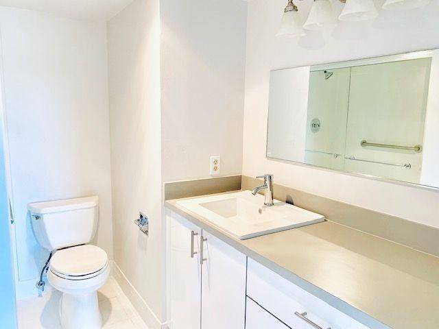 bathroom with tile patterned flooring, vanity, and toilet