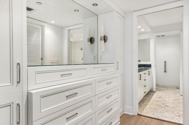 bathroom with vanity and hardwood / wood-style flooring