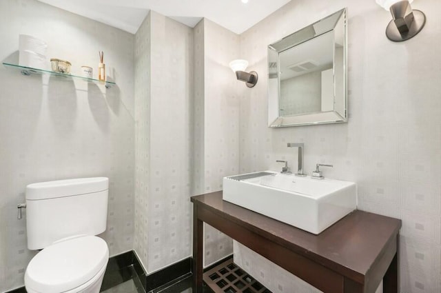 bathroom featuring toilet and sink