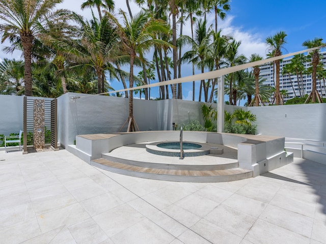 view of patio / terrace featuring an in ground hot tub