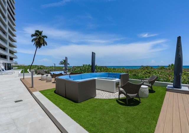 view of swimming pool with a yard, a water view, and an outdoor hangout area