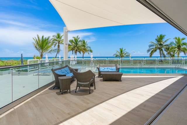 view of swimming pool with outdoor lounge area and a water view