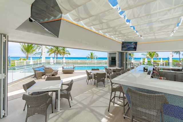 view of patio / terrace with a fenced in pool and an outdoor bar