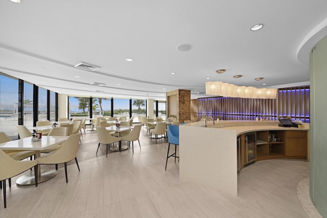 kitchen featuring pendant lighting, floor to ceiling windows, and light tile patterned floors